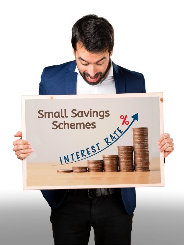 A man holding a poster showing small saving schemes interest rates hiked including Sukanya samriddhi yojana